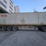 Standard shipping container staged at Quanzhou Northern Garment's warehouse in Jinjiang, ready to be loaded with finished bulk apparel cartons for overseas delivery.