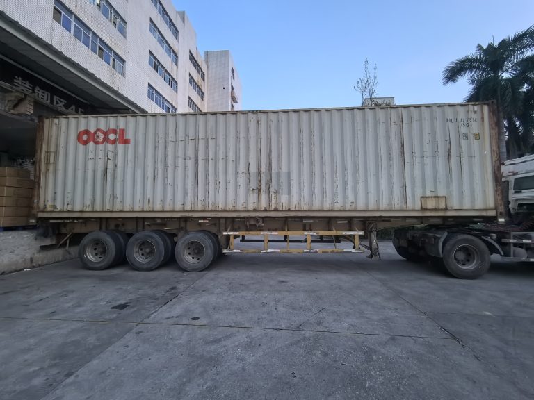 Standard shipping container staged at Quanzhou Northern Garment's warehouse in Jinjiang, ready to be loaded with finished bulk apparel cartons for overseas delivery.