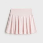 Women's pale blush pink athletic skort, front view, white studio background