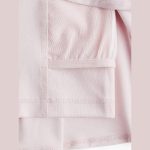 Pale blush pink skort interior detail close-up, mesh panels and flatlock seams