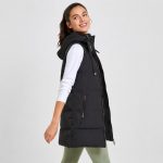 Women's black puffer vest model side profile walking, full zip, hood, side zip pocket visible, long length