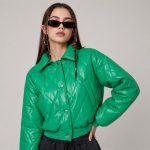 Women's emerald green diamond-quilt puffer jacket model alt pose, snap button front, structured collar, twin welt hand pockets