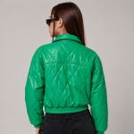Women's emerald green diamond-quilt puffer jacket model back view, structured collar, clean rear construction, elasticated hem