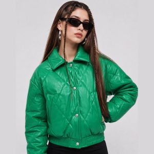 Women's emerald green diamond-quilt puffer jacket model front view, snap button front, structured collar, twin welt hand pockets, elasticated hem and cuffs, cropped fit, shiny finish