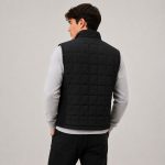 Men's black quilted vest model back view, square quilt pattern, vertical ribbed side panels