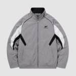 Men's windbreaker in grey with white panels and black piping, flat lay front view product photo, full zip, stand collar, side pockets, subtle branded chest logo