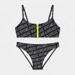 Women's black and white GIVEMEABREAK letter print bikini set flat lay front view, triangle bralette top with neon yellow front zip, side-tie bottom V-cut leg