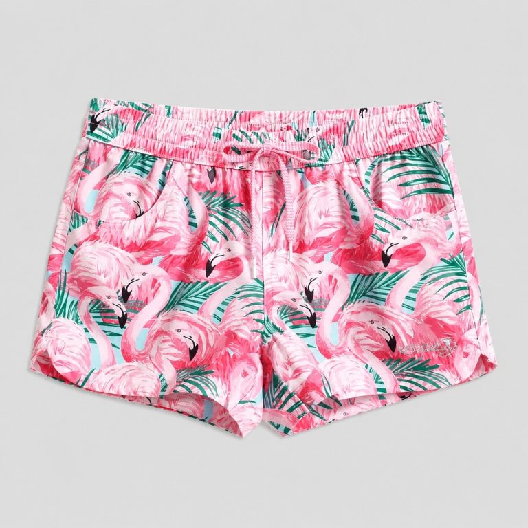 Front flat-lay multicolor flamingo + tropical leaf print swim trunks