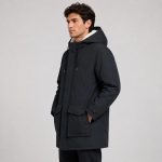 Men's sherpa-lined hooded parka jacket in black - model side view