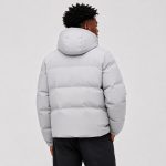 Men's hooded puffer jacket in light gray with horizontal quilt channels and adjustable hood - model back view, OEM wholesale outerwear