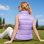 Women's sleeveless puffer vest (gilet) in lavender with stand collar, full zip, twin zip hand pockets, floral print interior lining - model back view, OEM wholesale women's outerwear