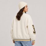 Women's varsity bomber jacket in cream wool blend with letter patches, snap-button front, ribbed trim - model back view, OEM wholesale women's outwear