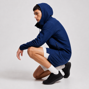 Men's navy hooded athletic jacket, crouching pose, logo-free shoes and socks