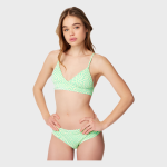 Young woman modeling a green and white patterned bikini with a v-neck bralette top and high-cut bottoms, standing front-facing with hands on hips in a studio setting.