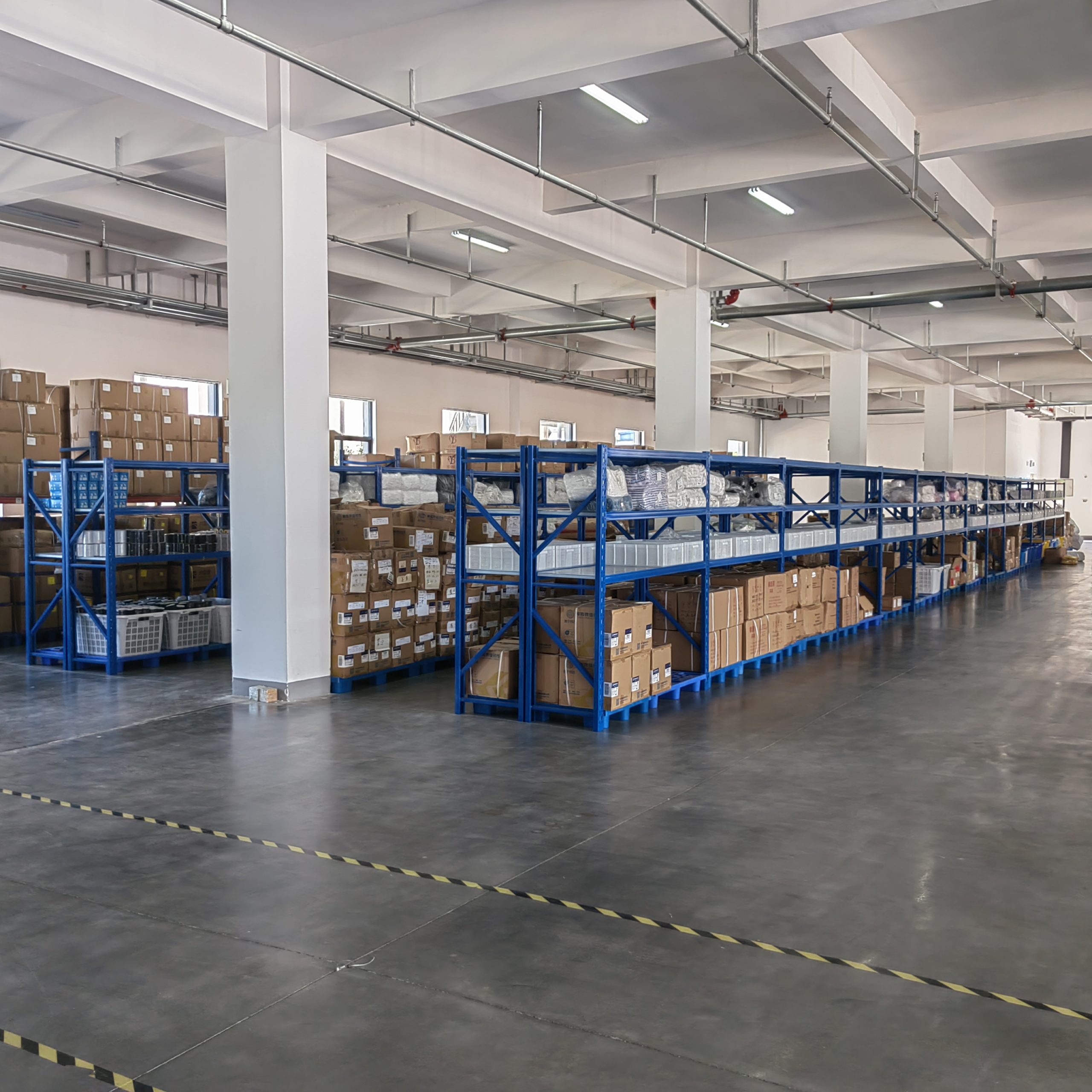 Heavy duty racking system organizing packaging materials and trims inside the Quanzhou Northern Garment warehouse