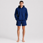 Men's navy hooded athletic jacket, Western model, standing front view, barefoot, white studio