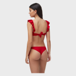 Back view of a woman modeling a red bikini with ruffled cap sleeves and a tied bow closure at the back.