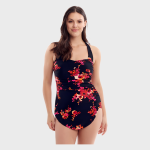 Front view of a woman modeling a navy blue one-piece swimsuit with a vibrant pink, red, and orange floral print, featuring ruched detailing at the waist against a white studio background.