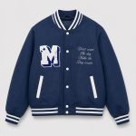Boy's navy blue classic American varsity letterman bomber jacket flat lay product photo front, white chenille M letter patch on left chest, white cursive embroidered quote 'Don't count the day Make the Day counts' on right chest, white snap button front closure, ribbed collar cuffs and hem with white double stripe trim, two slanted side pockets with white trim, clean light gray background for B2B catalog