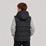 Boy's black and white speckle/terrazzo print quilted puffer vest back view, hood up, sleeveless relaxed fit, kid model back view with brown hair wearing heather gray sweatshirt underneath and black pants, white studio background, no text logo or patch