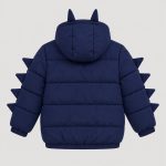 Boy's navy blue puffer jacket flat lay product photo front, hood up with two dinosaur horns on top, full-length zipper front, two zip pockets at front waist, three 3D triangular fabric spikes visible on each sleeve (front angle), ribbed cuffs and hem, clean light gray background for B2B catalog, no text or logo