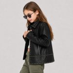 Girl's black studded leather (PU faux leather) jacket back view, point collar, vertical center back seam, studded waistband and hem band, kid model with hair down, heart-shape sunglasses side profile, olive green cargo pants