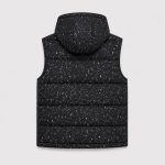 Boy's black and white speckle/terrazzo print quilted puffer vest flat lay product photo back, hood, sleeveless relaxed silhouette, clean white studio background for B2B catalog, no text logo or patch