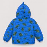 Boy's royal blue diamond quilted puffer jacket flat lay product photo back, hood up with 3D fabric dinosaur spike/horn on hood edge, allover scattered cartoon dinosaur silhouette print and 'WILD ONE' slogan and lightning bolt decorations continuing across back, lime green drawstring toggle at hem, ribbed cuffs and hem, clean light gray background for B2B catalog