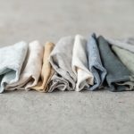 Stacked fabric swatches showing recycled polyester and spandex textile samples on neutral background