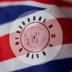 UKCA conformity marking stamp on a textile care label with UK flag colors in the background.
