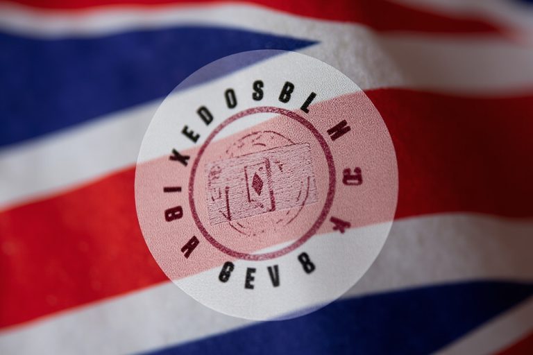 UKCA conformity marking stamp on a textile care label with UK flag colors in the background.