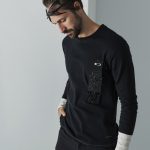 Smart garment with embedded electronic sensor strip and conductive thread, minimalist product photography.